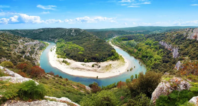 in the scrubland of nîmes, gard, occitanie, formerly languedoc-roussillon, the river dug a superb loop in the limestone aerial and panoramic view of this mediterranean landscape