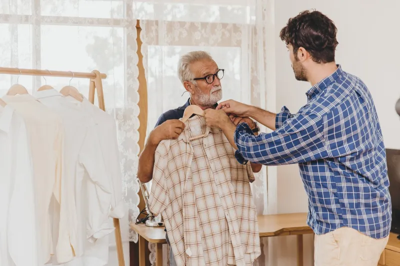 young man help elder senior choose good clothes for holiday outing travel