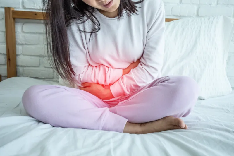 woman have bladder pain sitting on bed in bedroom after wake up feeling so sick and painful,healthcare concept