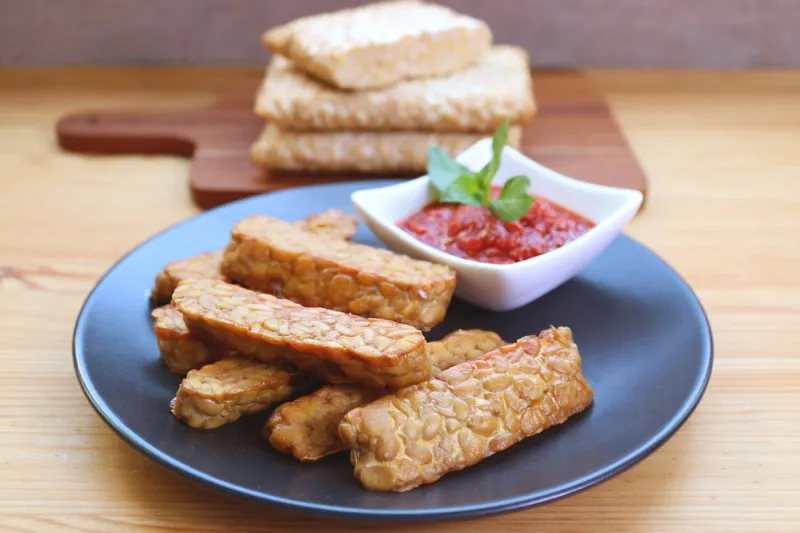 pan fried tempeh with marinara sauce, a healthy and tasty whole foods plant-based dish