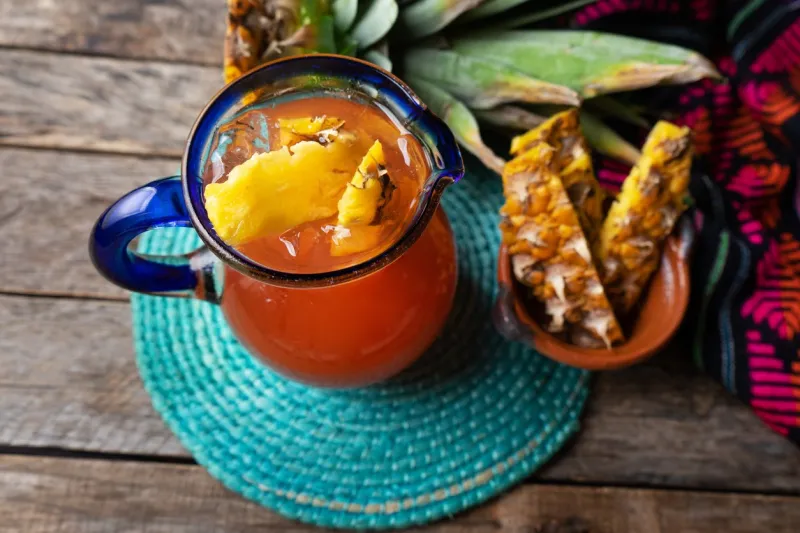 traditional mexican fermented beverage called tepache made with pineapple and cinnamon