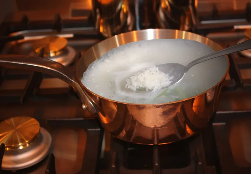 rice being cooked in boiling water