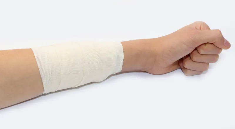 bandaged arm of the boy after the terrible burn on white background