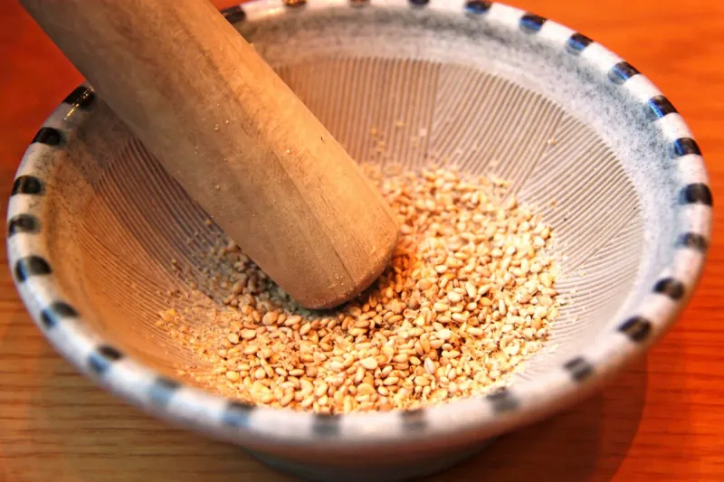 sesame seeds in a suribachi, japanese mortar and pestle