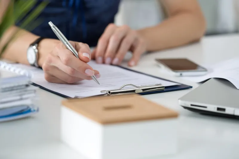 close-up of female hands woman writing something sitting at her office