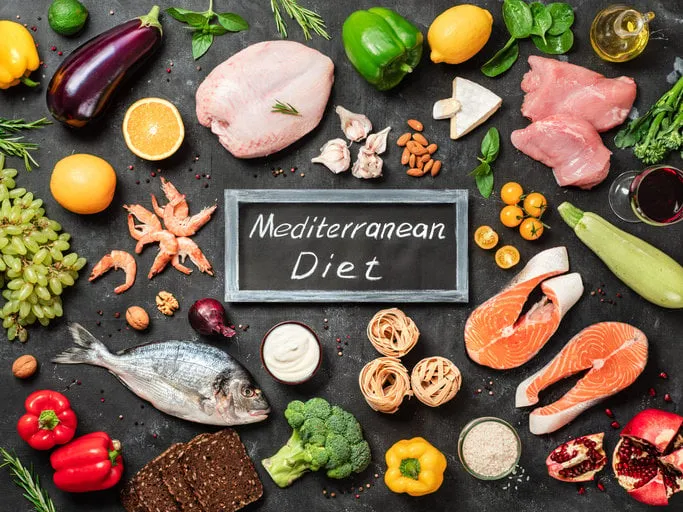 mediterranean diet concept top view of food ingredients and chalkboard with words mediterranean diet in center dark background flat lay
