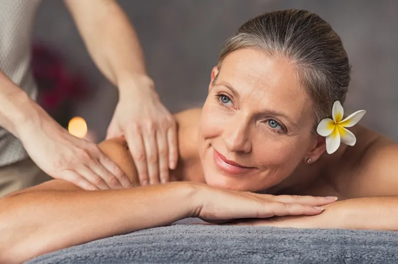 senior woman in spa salon getting massage closeup of a beautiful woman during spa treatment beautiful mature woman receiving massage of shoulder at beauty salonr