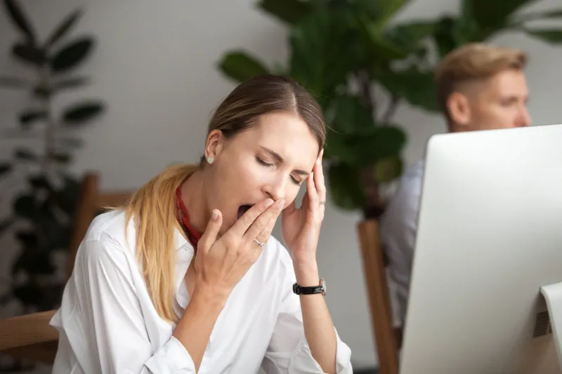 bored businesswoman yawning at workplace feeling no motivation or lack of sleep tired of boring office routine, exhausted restless employee gaping suffering from chronic fatigue or overwork concept