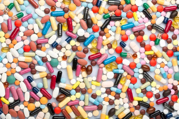 scattered colorful medical pills and pharmaceuticals remedy