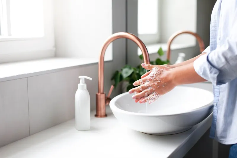 woman washing hands under water tap self care and hygiene close up of female hand infection prevention liquid antibacterial soap and foam step by step instruction step