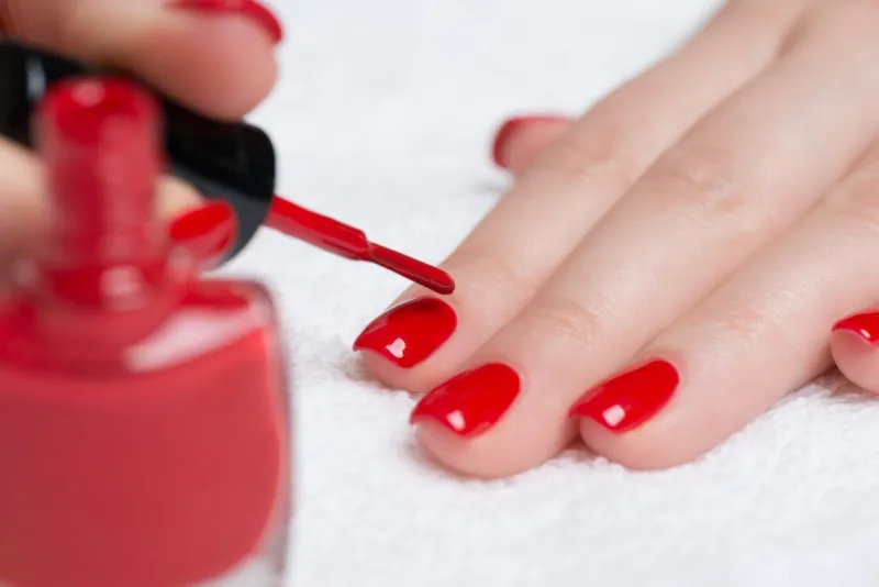 beauty treatment photo of nice manicured woman fingernails with red nail polish