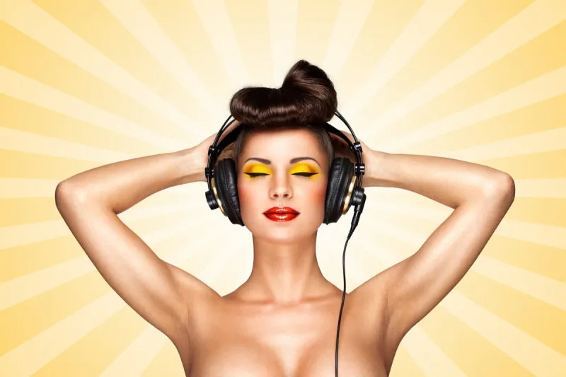 retro photo of a nude pin-up girl with big vintage music headphones on colorful abstract cartoon style background