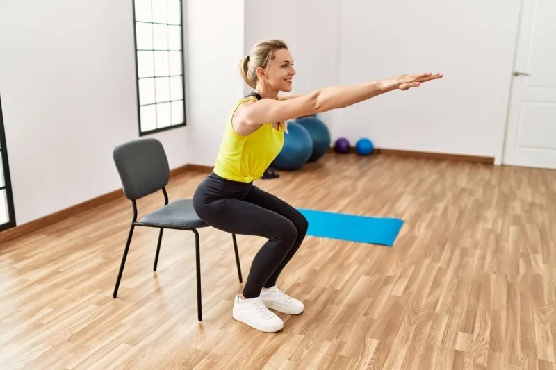 young blonde girl smiling happy training at sport center