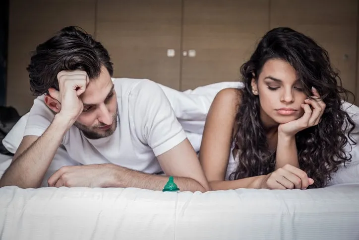 men and women are discussing the use of condoms