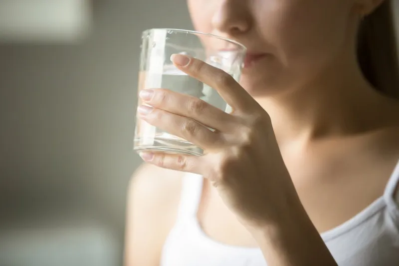 female drinking from a glass of water health care concept photo, lifestyle, close up