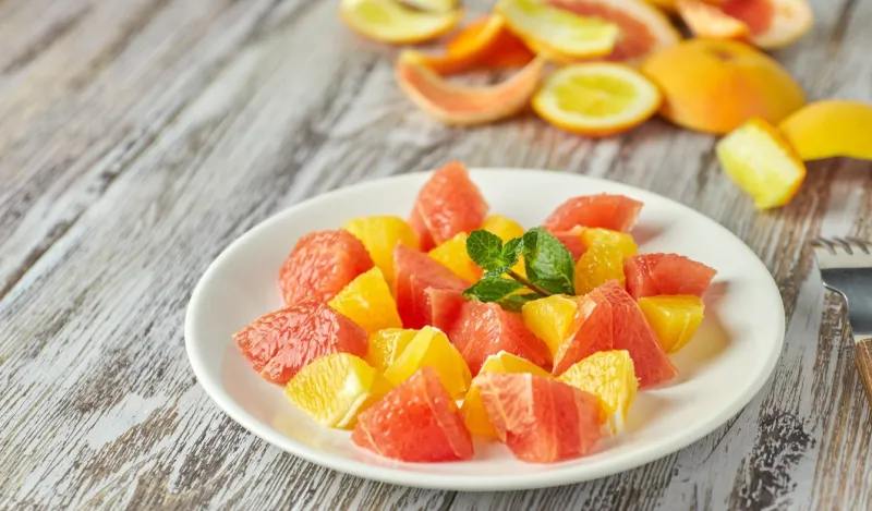 orange-grapefruit citrus salad on a shabby wooden table close-up summer vitamin salad healthy food dietary salad
