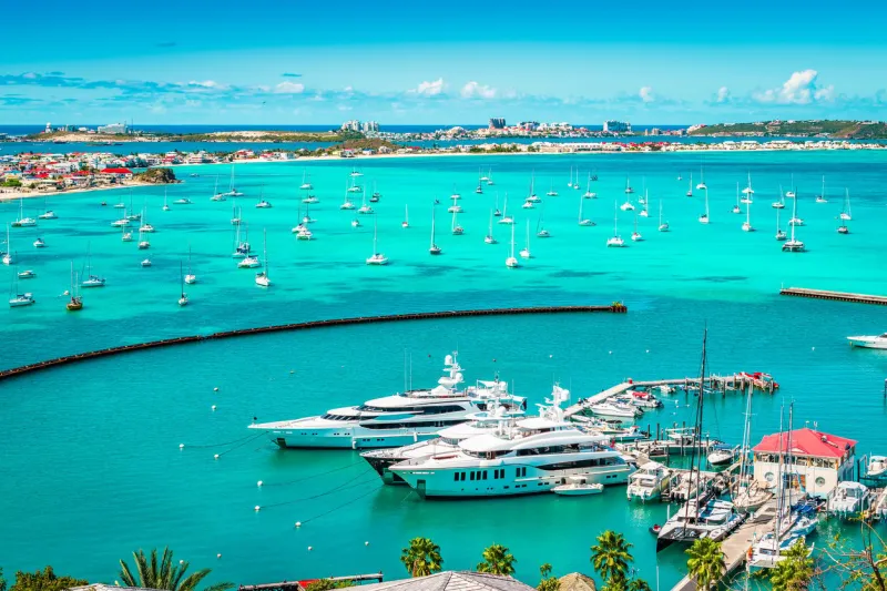 bright and colorful harbor view with yachts and boats in the marina of marigot in saint martin, french side of the caribbean island