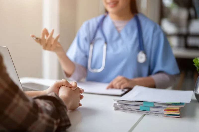 close-up hand image of a serious patient having a medical consultation with a professional doctor at a hospital medical checkup, counseling, and diagnosis of disease