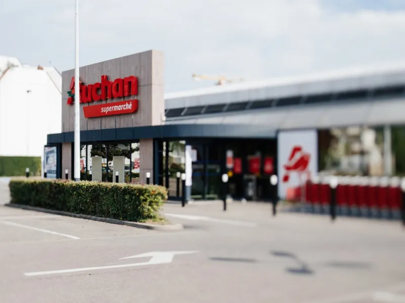 strasbourg, france- apr 13, 2020  closed auchan supermarket store with empty parked during covid-19 coronavirus pandemic situation - tilt-shift lens view