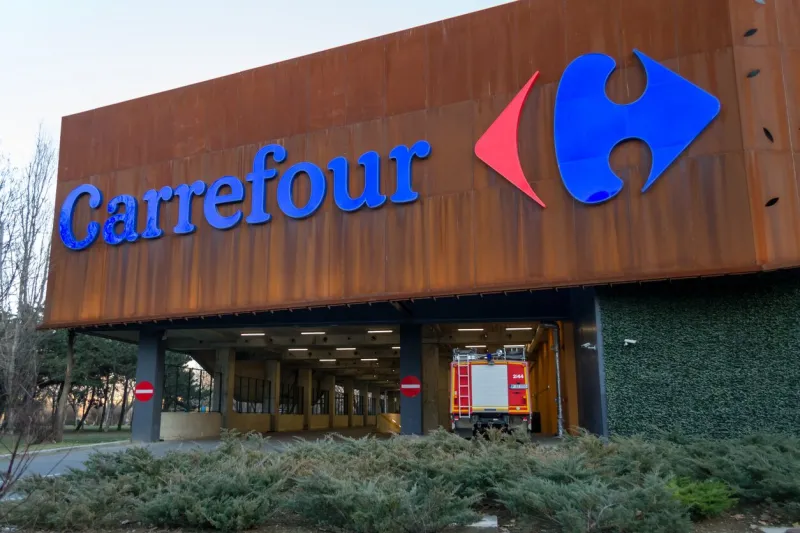 bucharest, romania - 26 february 2019  carrefour supermarket logo on parklake shopping center mall carrefour is one of the largest hypermarket chains in the world fire truck and parking exit below