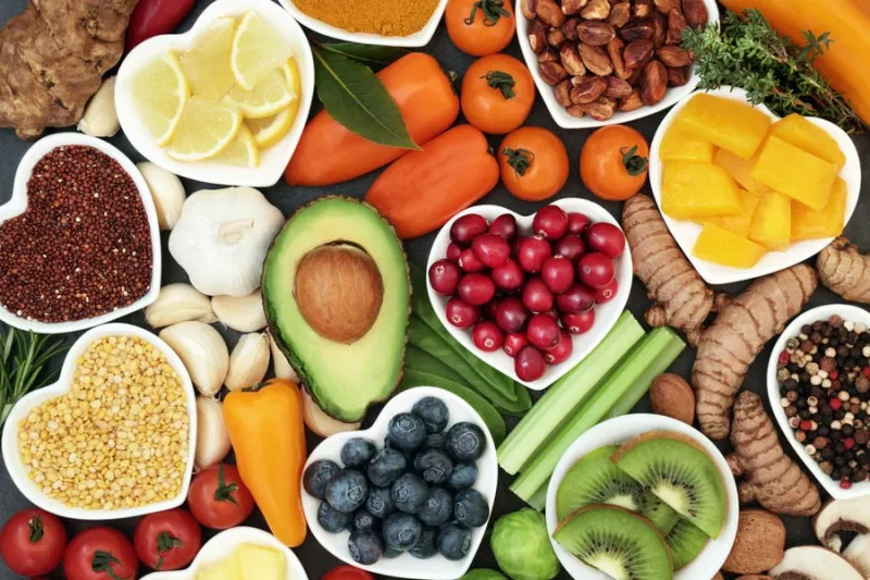 health food for fitness concept with fresh fruit, vegetables, pulses, herbs, spices, nuts, grains and pulses high in anthocyanins, antioxidants,smart carbohydrates, omega 3 fatty acids, minerals and vitamins