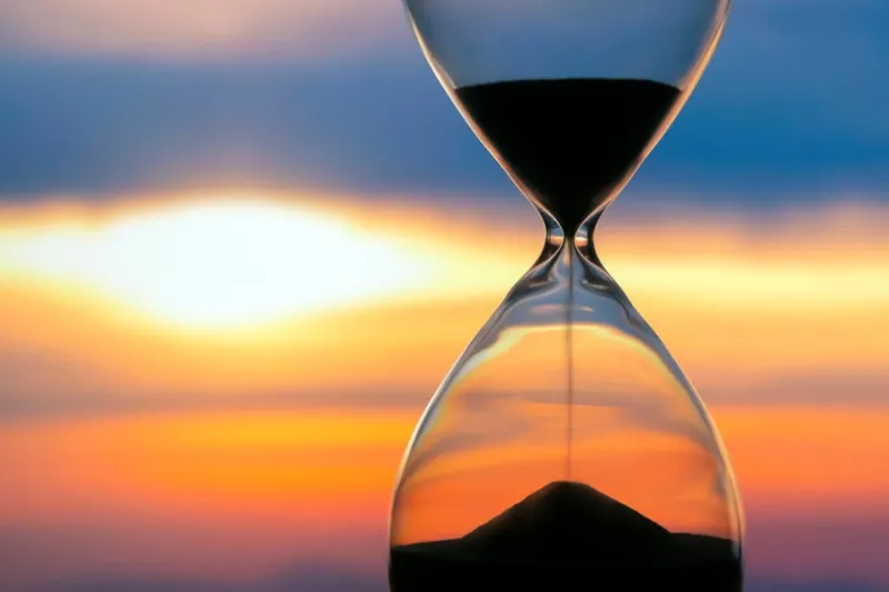 hourglass on the background of a sunset the value of time in life an eternity