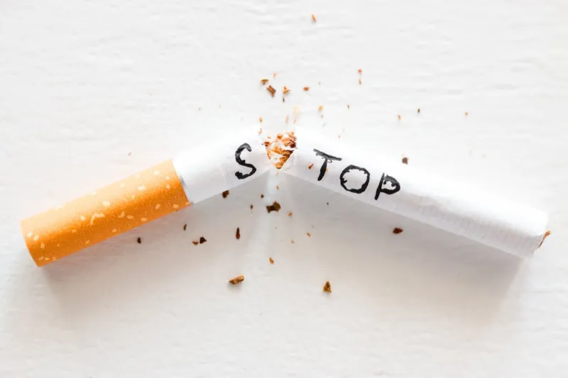 broken cigarette with the word stop stop smoking concept closeup