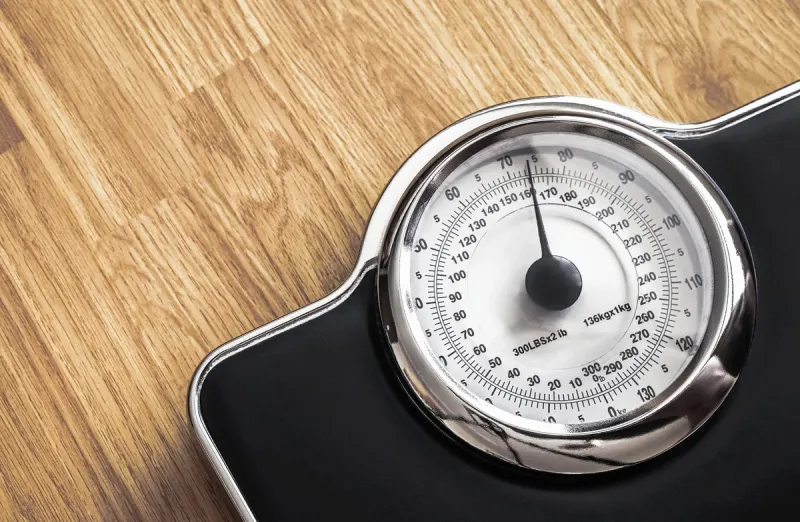 weight scale on wooden floor