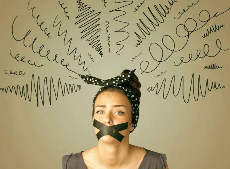 young woman with taped mouth and curly lines around her head