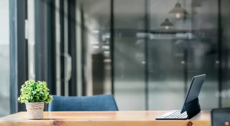 mockup tablet with magic keyboard on wooden tablet in dark tone office room