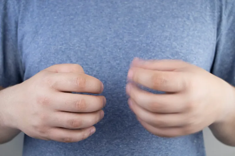 a patient with parkinson's disease has trembling hands tremor of the extremities in various diseases patient care concept