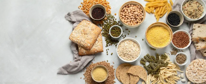 best sources of carbs on light gray background healthy food concept top view, flat lay, copy space, panorama