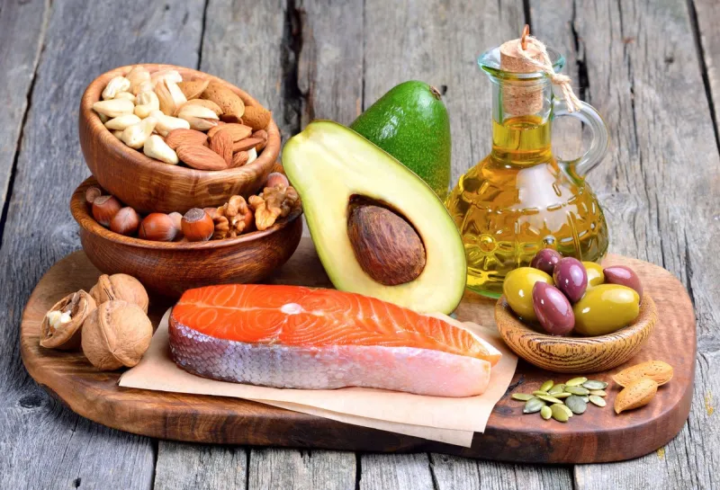 selection of healthy fat sources on wooden background