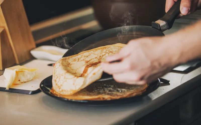 the process of cooking pancakes on a hot skillet