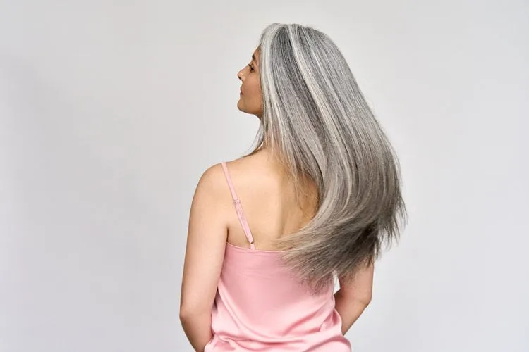 back view of senior mature middle aged older asian lady with long gray natural coloring vibrant silky hair dry hair replenishing healing treatment for women after menopause advertising concept