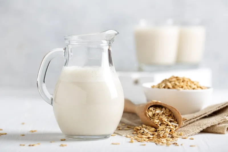 oat milk healthy vegan non-dairy organic drink with flakes