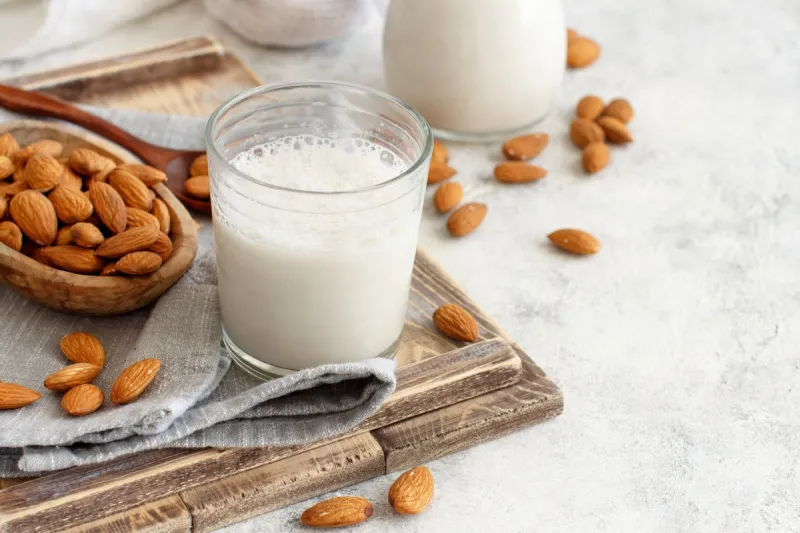 vegan almond milk, non dairy alternative milk in a glass close up