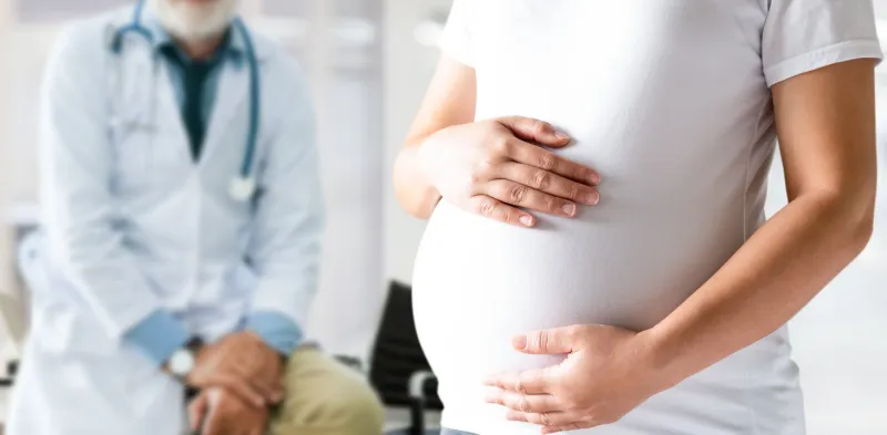 happy pregnant woman visit gynecologist doctor at hospital or medical clinic for pregnancy consultant doctor examine pregnant belly for baby and mother healthcare check up gynecology concept