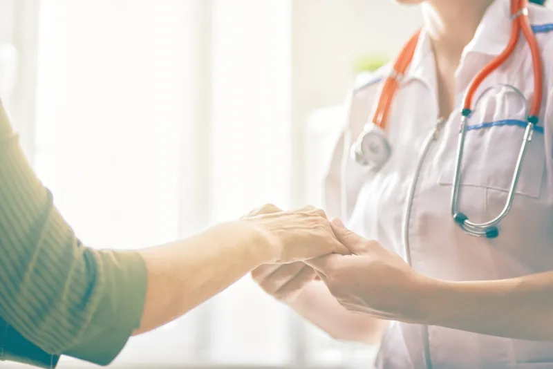 female patient listening to doctor in medical office