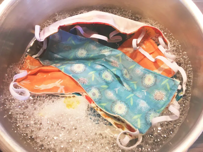 close up of boiling or washing cotton face masks in a pan