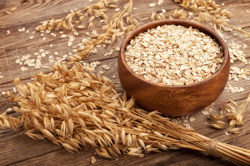 oat flakes in a bowl on the old board