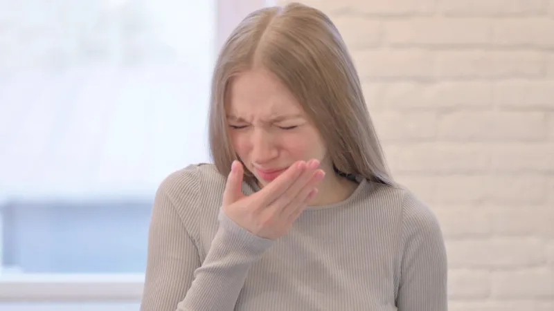 portrait of creative young woman suffering with cough