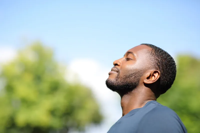 profile of a black man breathing fresh air in nature