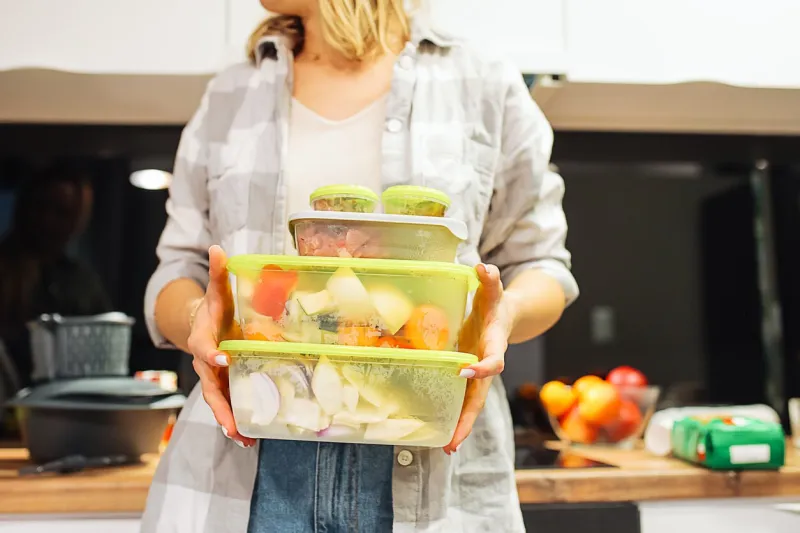 hands of woman hold plastic containers with different frozen foodstuffs cooking dinner at home kitchen hermetically sealed food storage homemade dish, recipe, food ingredients and tableware
