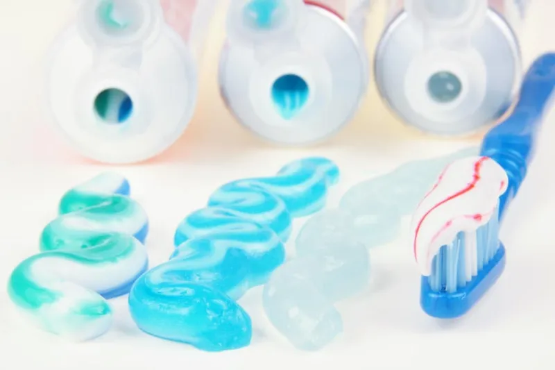 trois types de dentifrice dans des tubes avec brosse à dents
