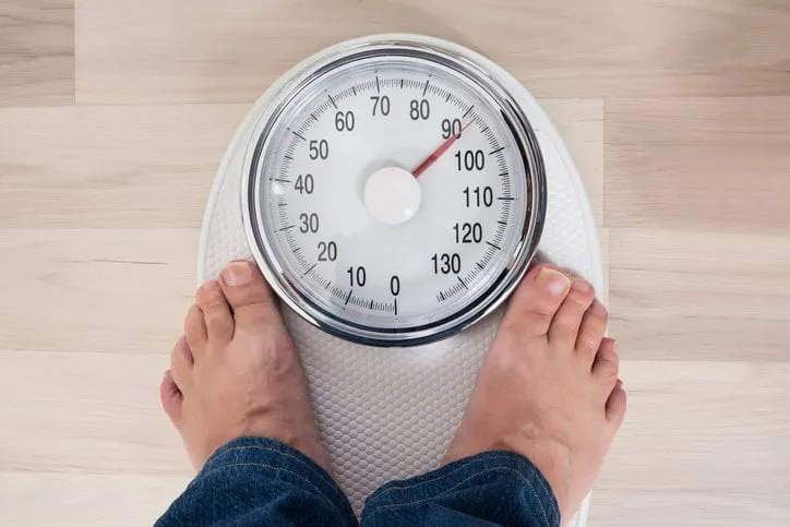 low section of a person standing on weighing scale
