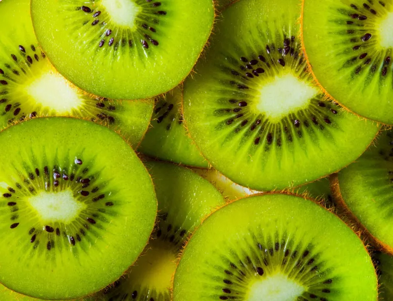 background made with a heap of sliced kiwis