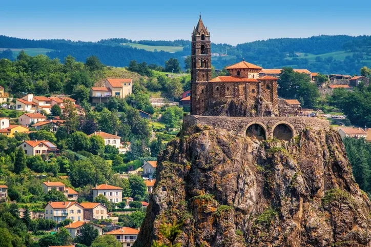 saint michel d'aiguilhe chapel sitting on a rock in le puy en velay, france