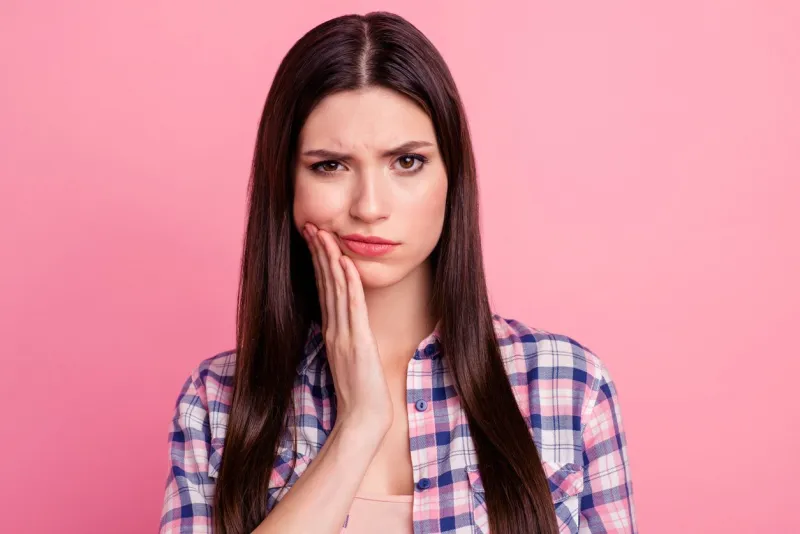close-up portrait of her she nice-looking attractive cute charming sad straight-haired lady having pain attack teeth damage care oral hygiene isolated over pink pastel background