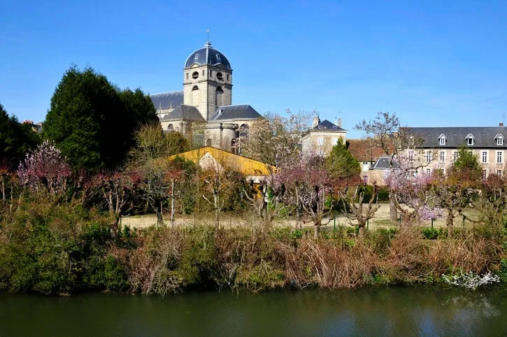 sarthe river bank and bell tower of basilica notre dame at alençon of the lower normandy region in france
